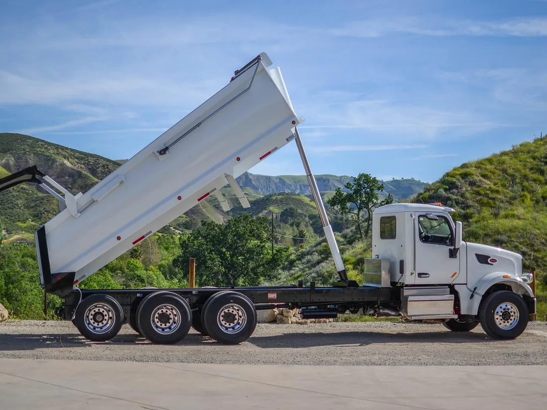White dump truck with bed raised